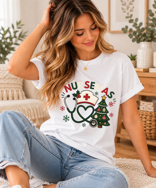 Woman wearing white Nursemas Christmas shirt with nurse hat, heart stethoscope, Christmas tree and snowflakes